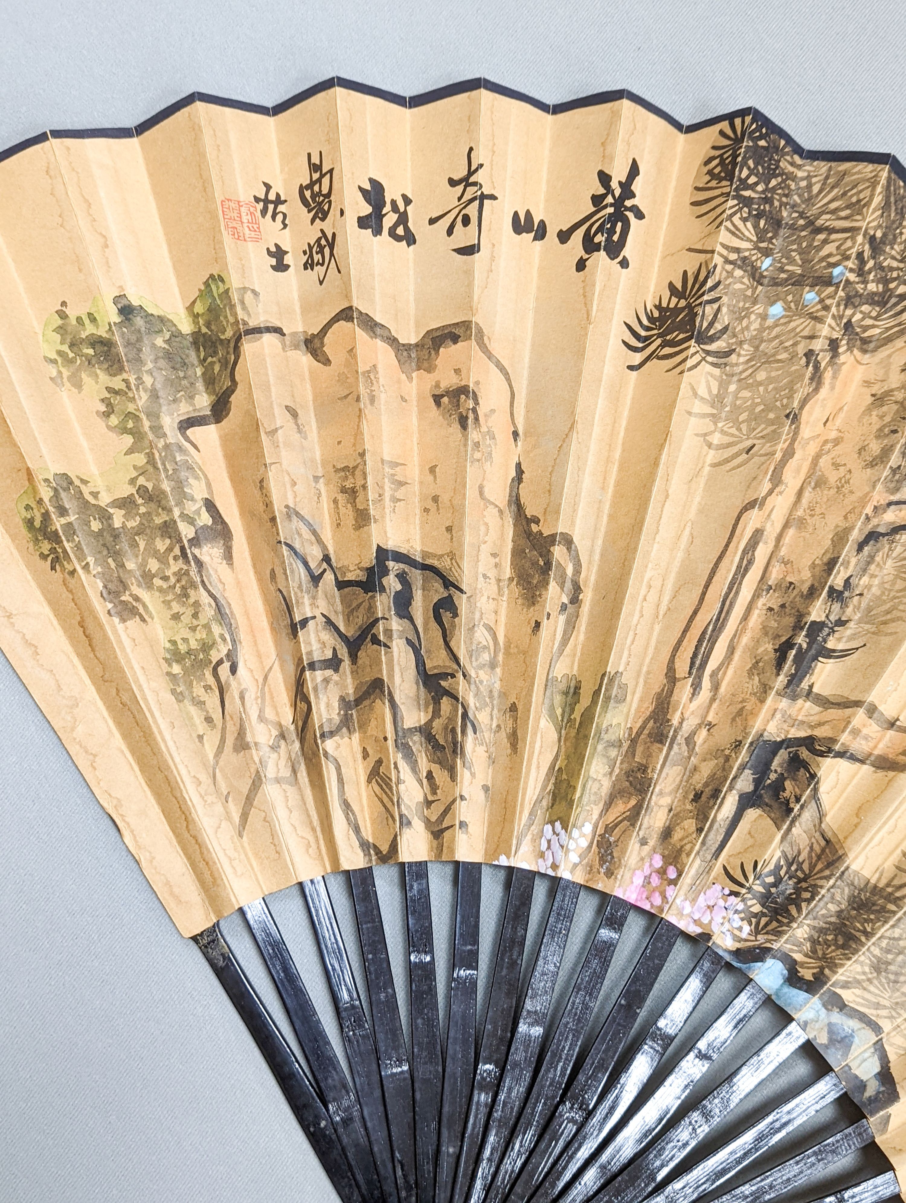A large Chinese fan, the leaf painted with a landscape, signed Radius 60cm